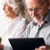 Elderly couple researching pension options online Elderly couple researching pension options online