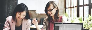 Female colleagues collaborating in the workplace Female colleagues collaborating in the workplace
