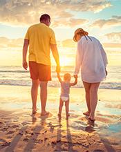 Young family walking along the beach